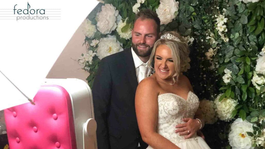 photo booth pink flowerwall bride groom